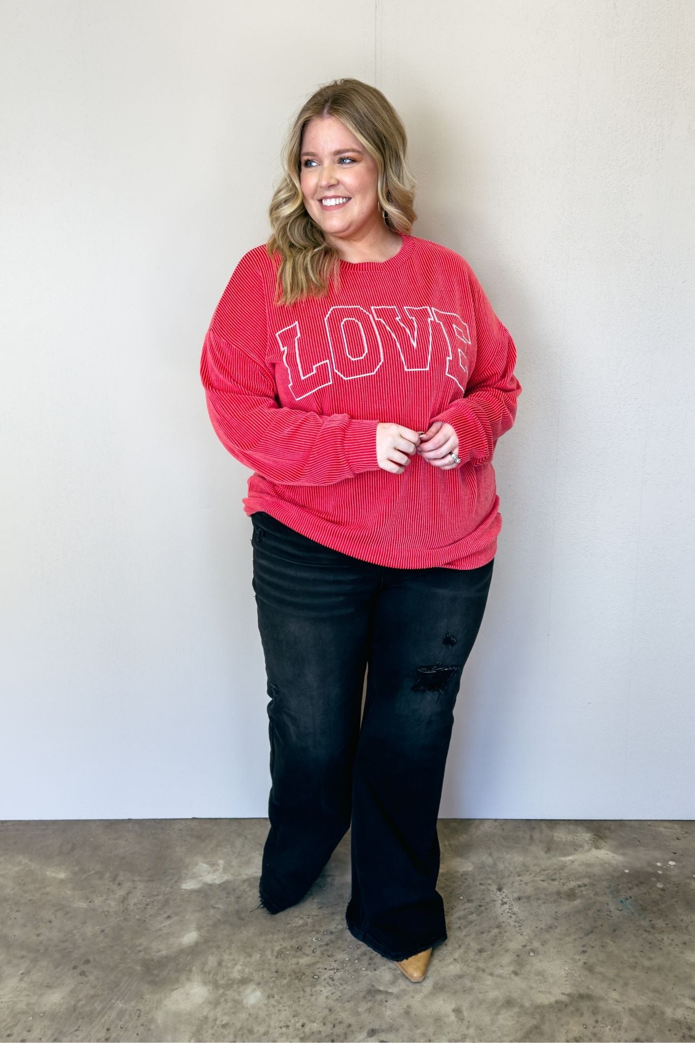 A cozy red sweater with the word "love" written on it. Perfect for spreading warmth and affection.