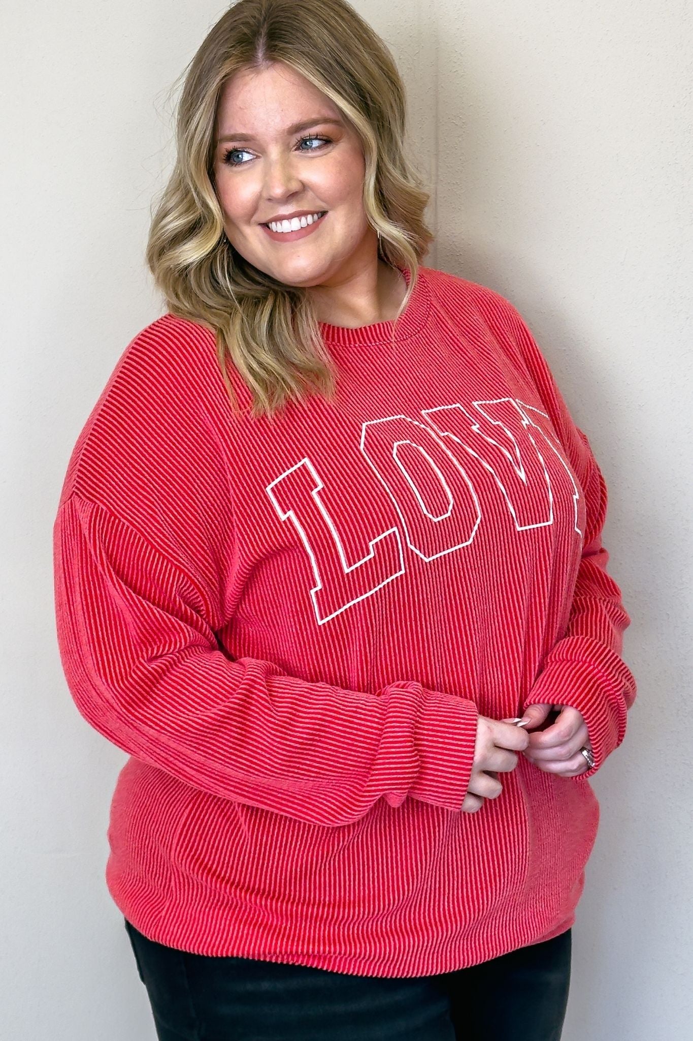 A cozy red sweater with the word "love" written on it. Perfect for spreading warmth and affection.