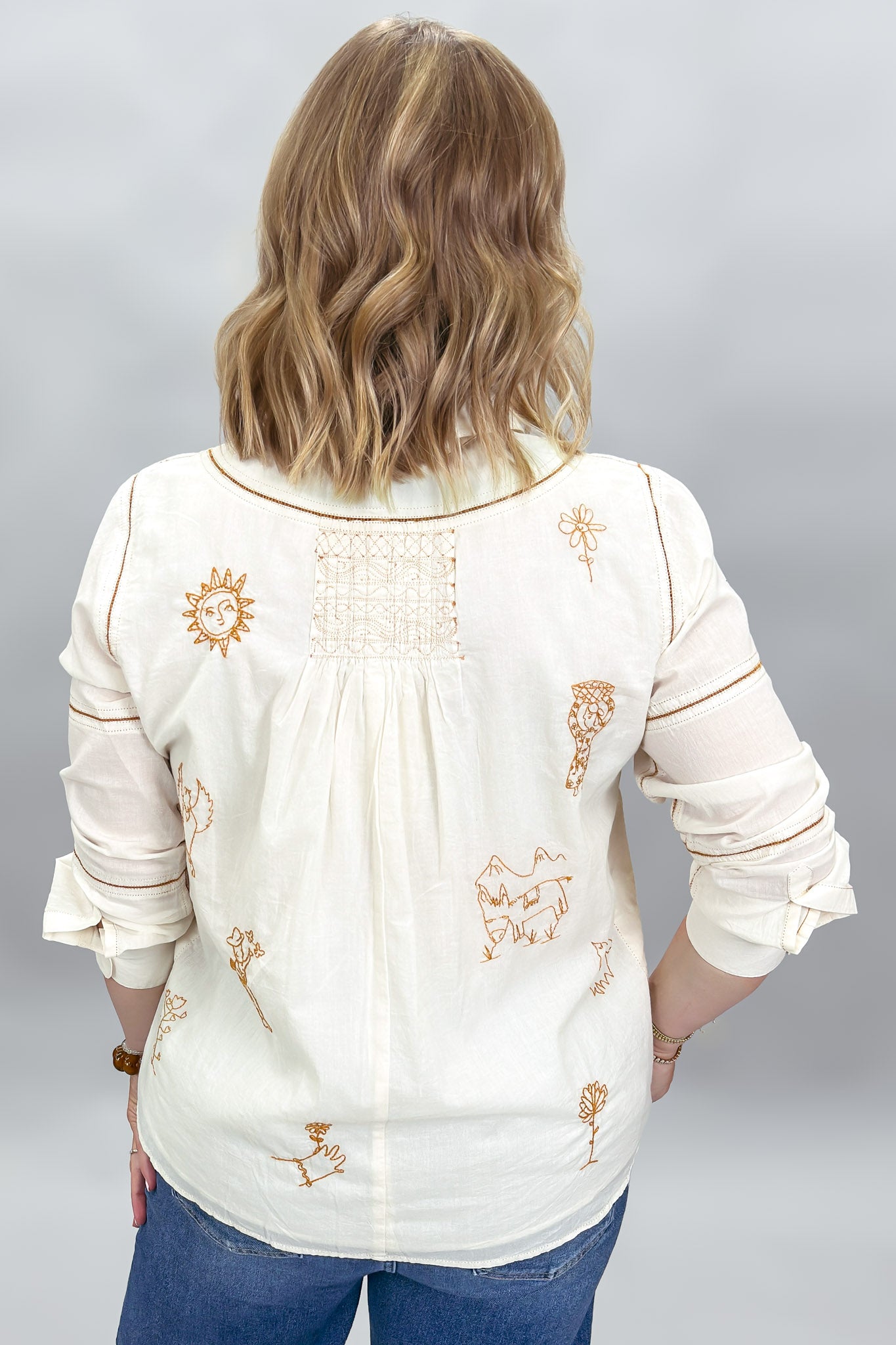 Ivy Jane ivory Milagro blouse, back view with bronze embroidery, gathered detail and contrast stitching.