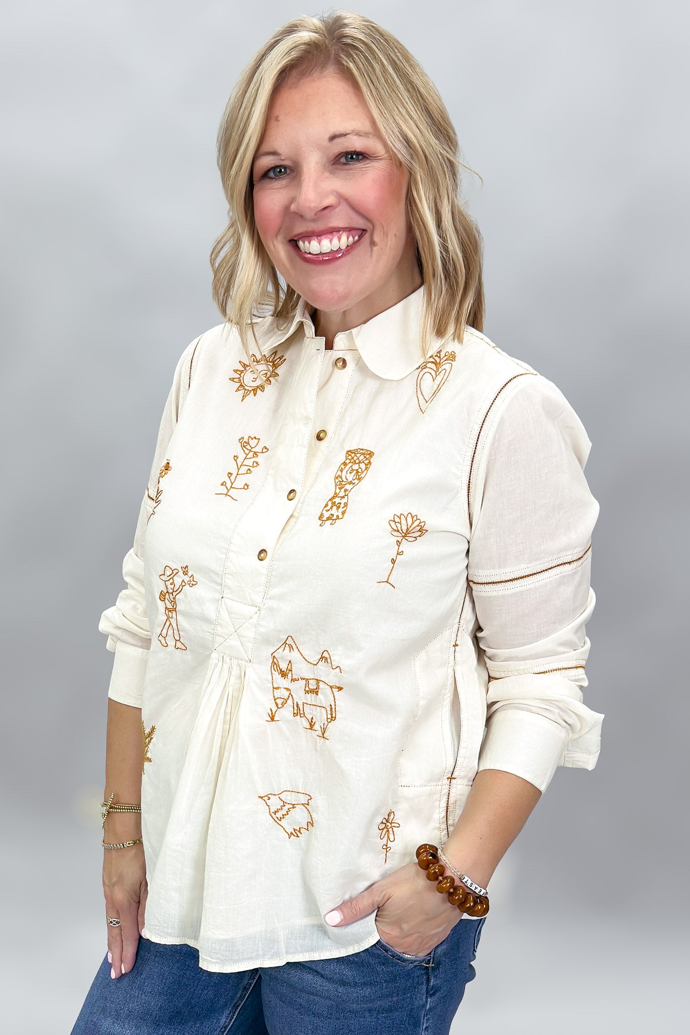 Ivy Jane ivory Milagro blouse, angled view showing embroidery, gathered front and stitched sleeve detail.