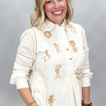Ivy Jane ivory Milagro blouse, opposite angled view showing bronze motifs and curved hem.