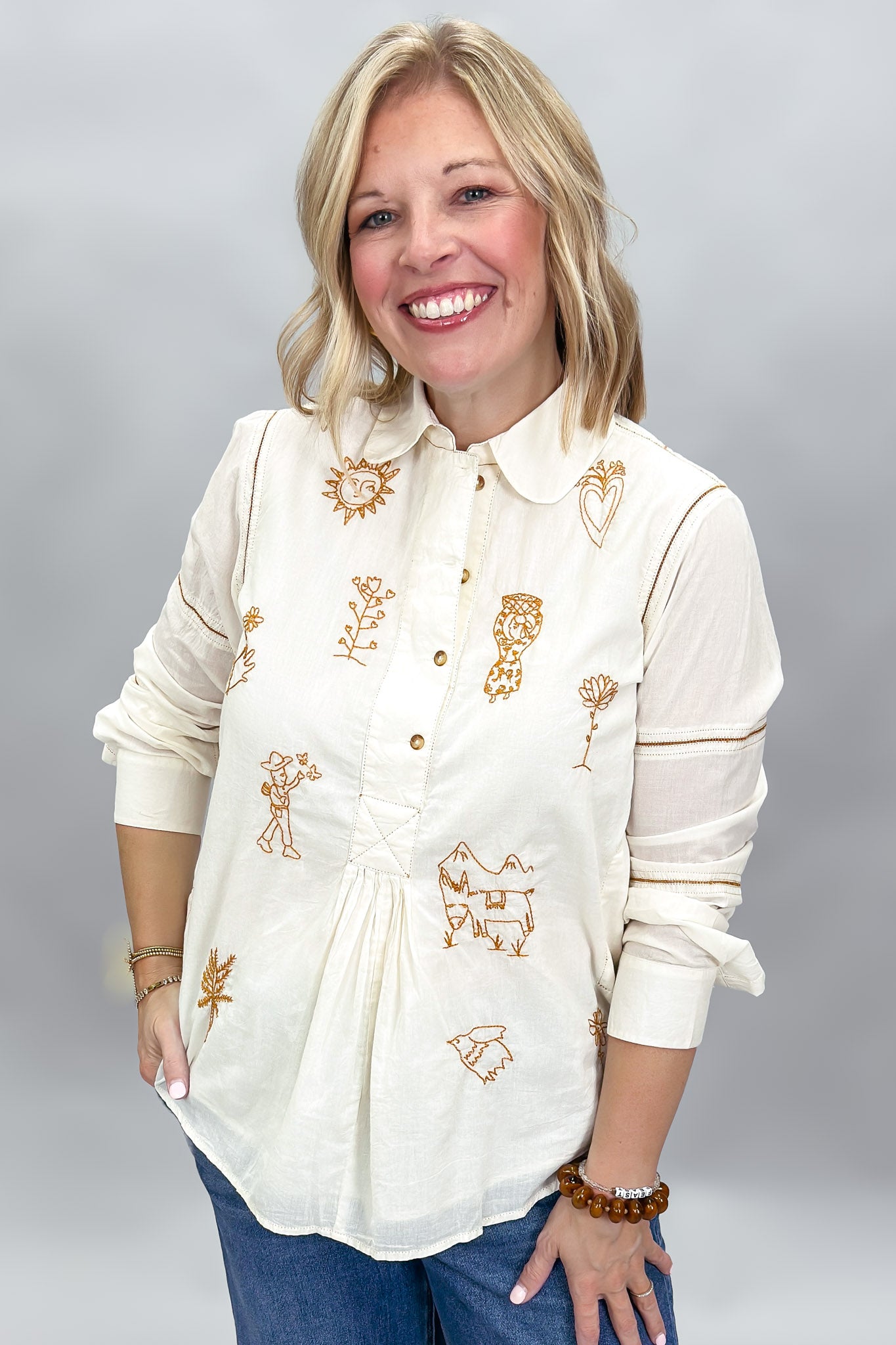 Ivy Jane ivory Milagro blouse, front view with rounded collar, bronze buttons and gathered placket detail.