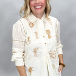 Ivy Jane ivory Milagro long-sleeve blouse, front view showing rounded collar and bronze embroidered motifs.