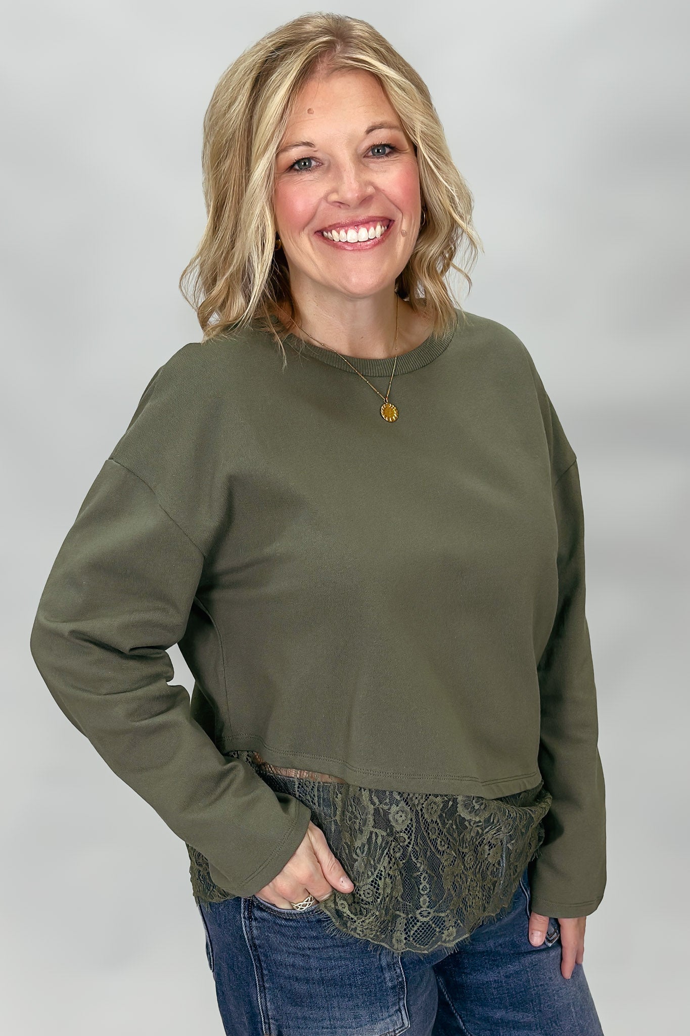 Army green Entro top showing crew neckline and layered lace hem