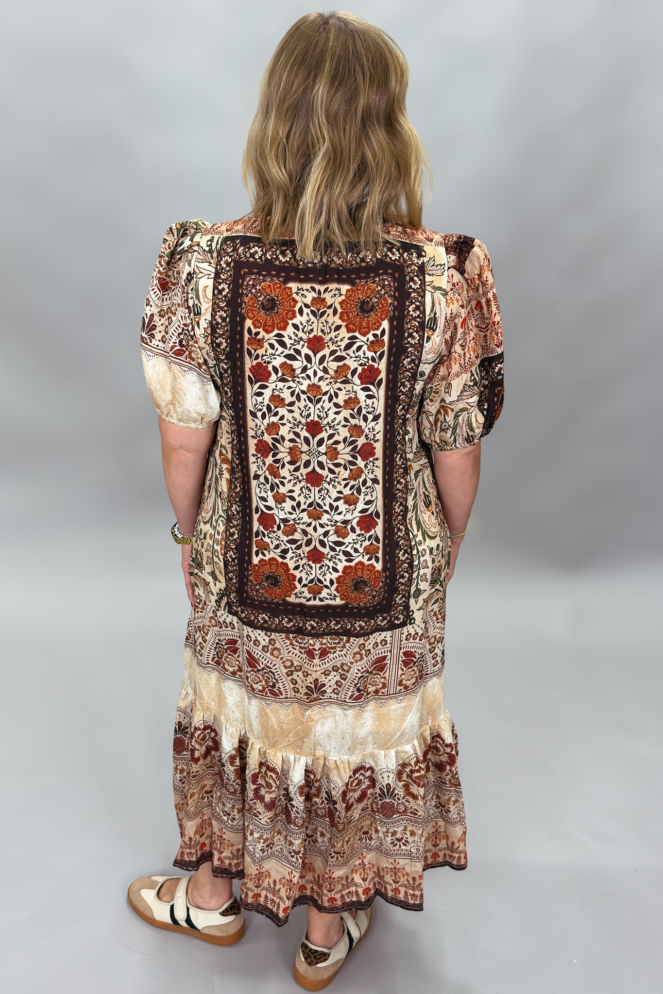 Back view of the Blown My Cover bohemian midi dress, highlighting the large framed patchwork panel of rust, brown, and cream floral and geometric motifs.