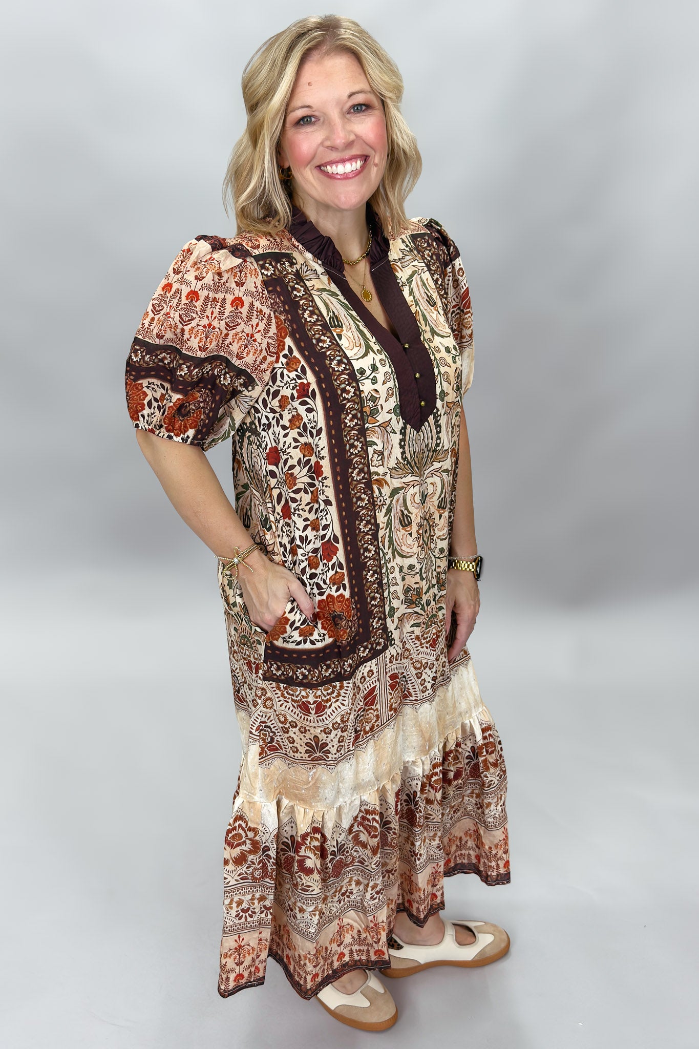 Three-quarter view of the Blown My Cover tiered floral midi dress, showing the rust, brown, and beige paisley print, short sleeves, and flowing skirt.