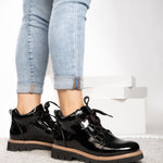 Close view of Corkys Campfire black crinkle patent finish and boot details