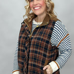 Staccato navy and brown plaid vest with mock neck and patch pockets; styling suggestion over a separate striped sweater.