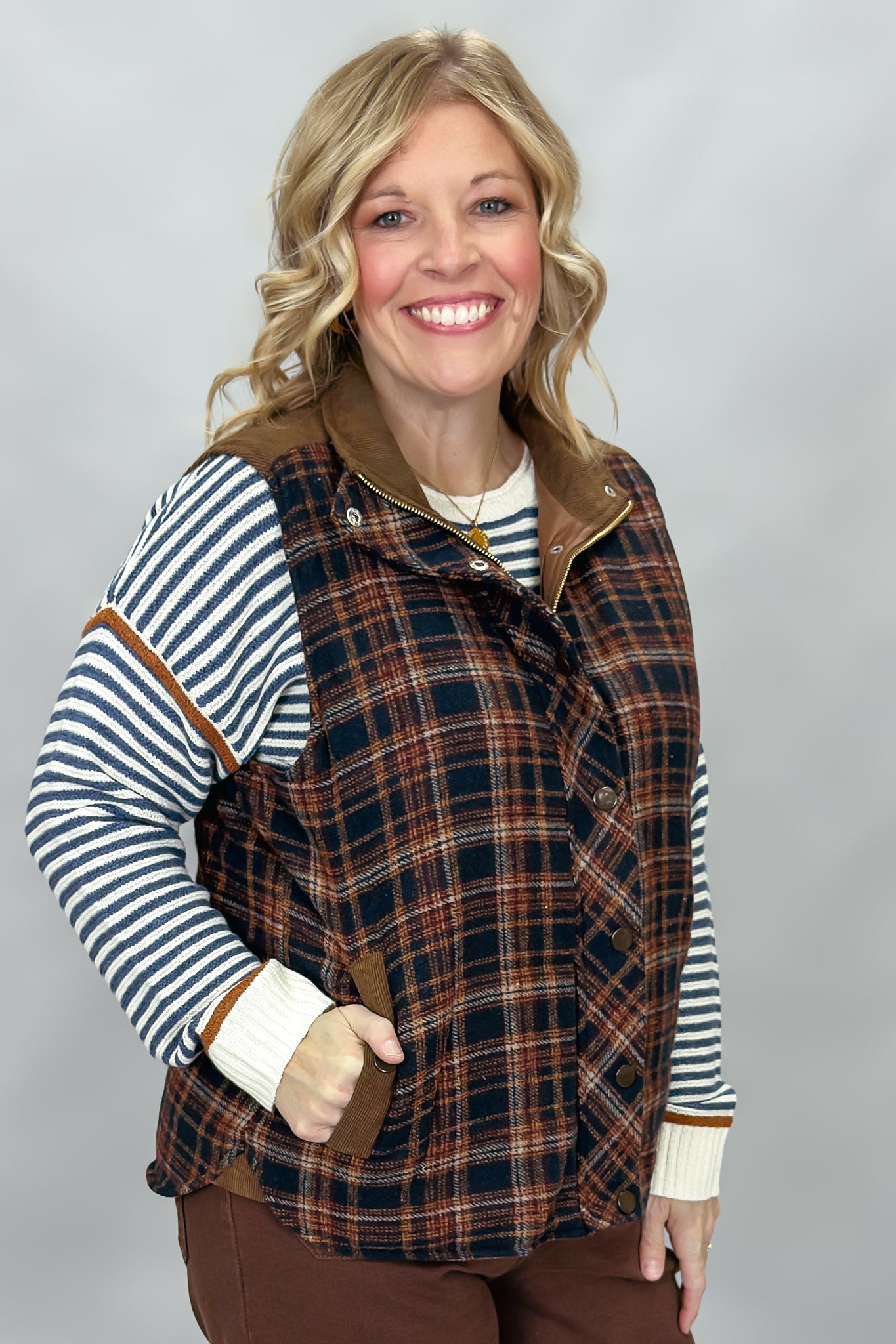 Staccato navy and brown plaid vest with mock neck and patch pockets; styling suggestion over a separate striped sweater.