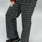 Just Black Denim black straight-leg jeans with cream polka dots; angled model view.