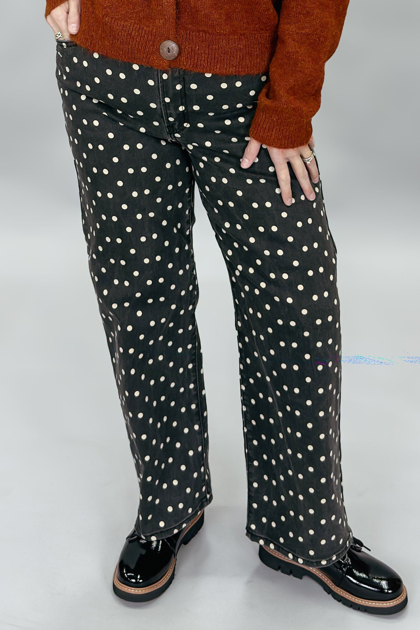 Just Black Denim black straight-leg jeans with cream polka dots; angled model view.