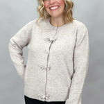 Compania Fantastica tan button-front cardigan with bow details; front model view.