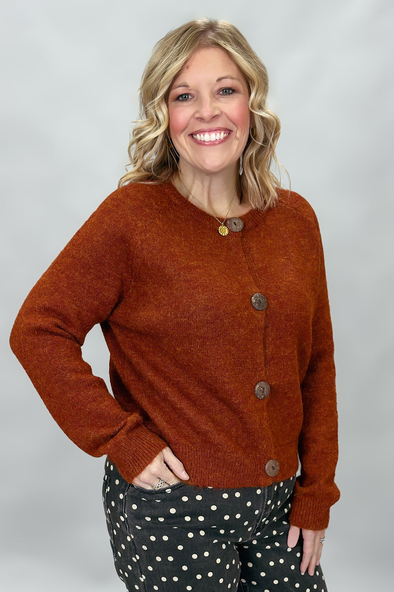 Compania Fantastica rust crewneck button-front cardigan; angled model view.