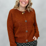Compania Fantastica rust crewneck button-front cardigan; front model view.