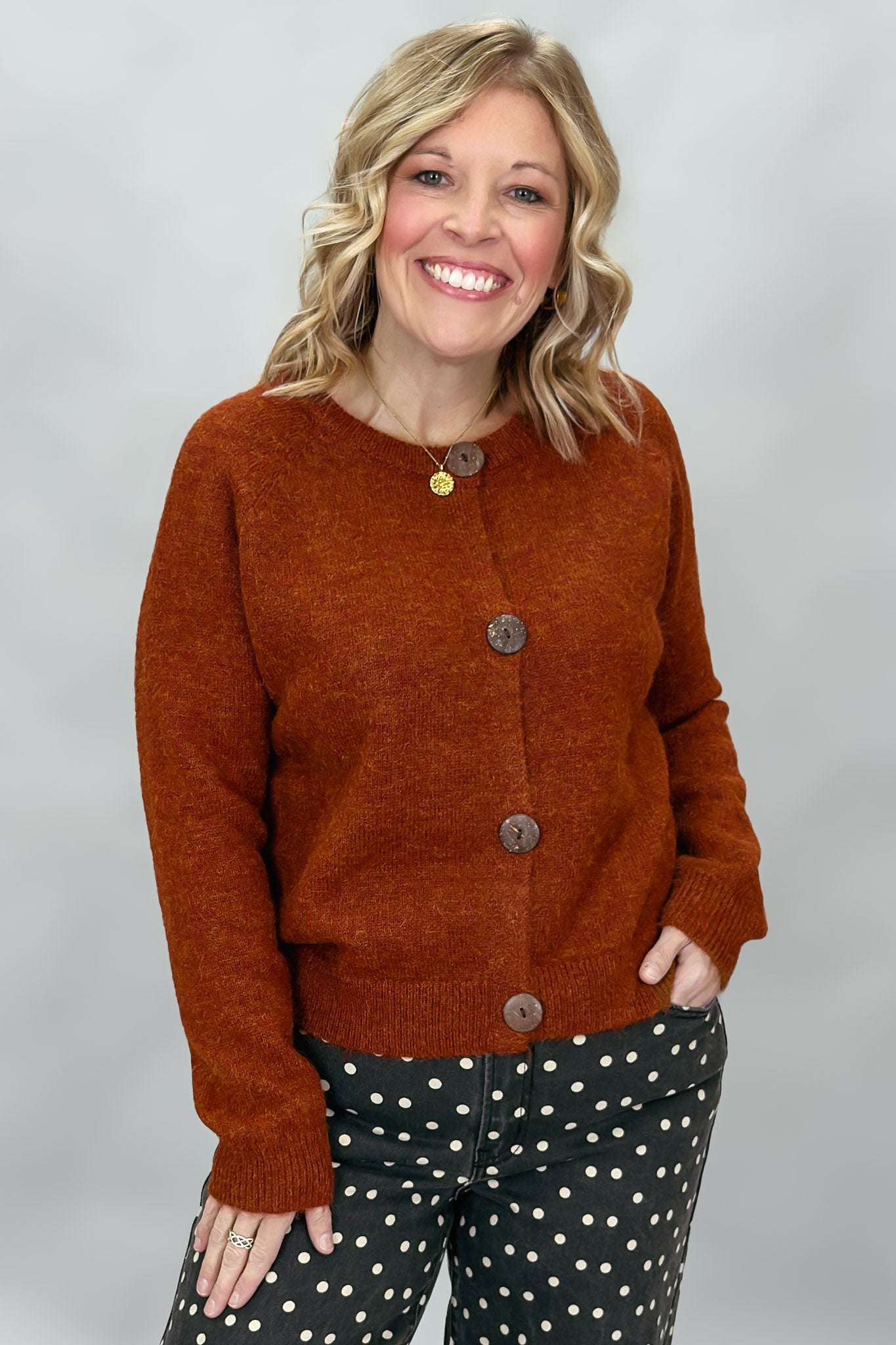 Compania Fantastica rust crewneck button-front cardigan; front model view.