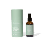Hico Candle Co. Golden Hour room spray in an amber-colored bottle beside a green tube