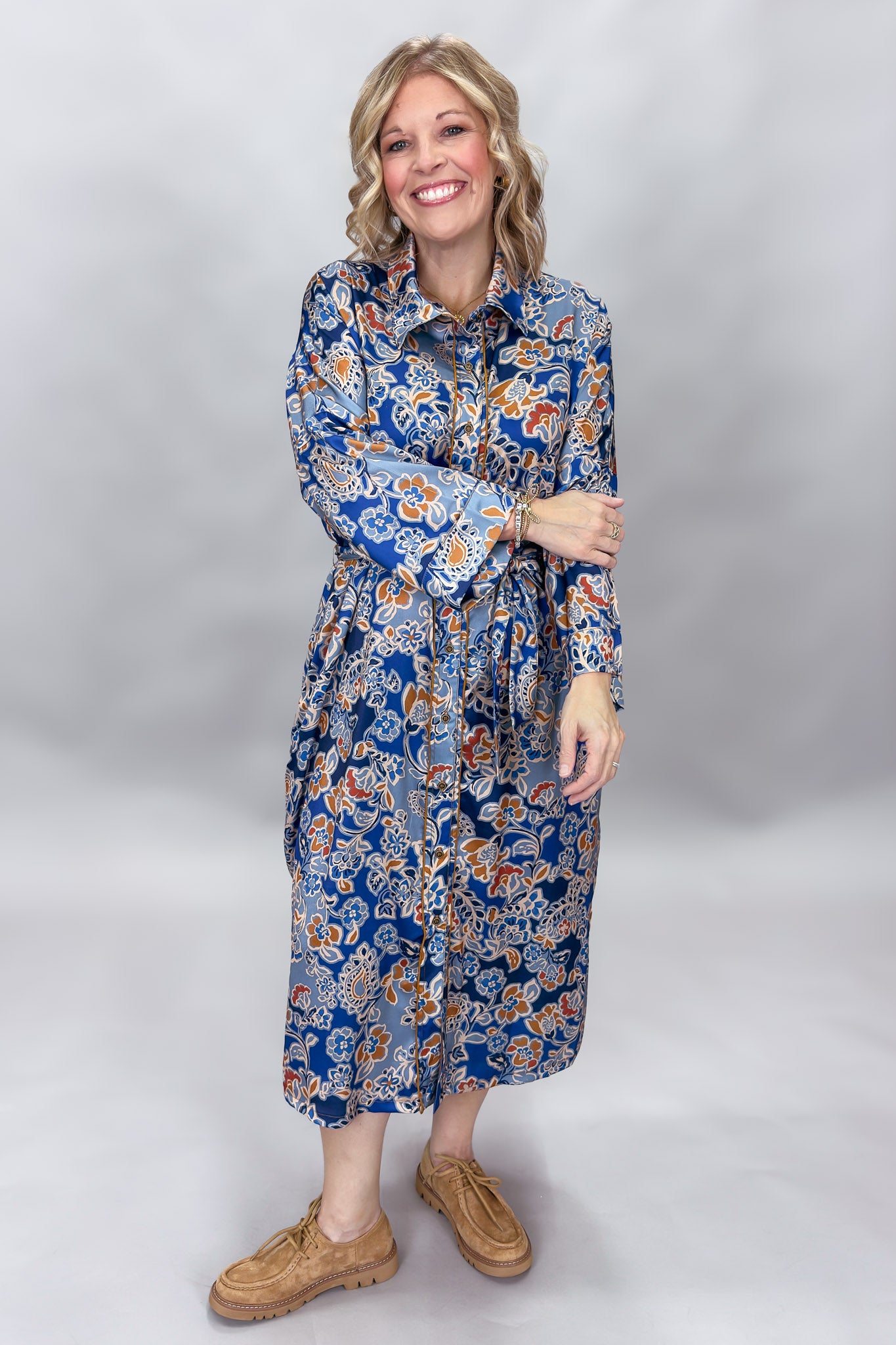 Uncle Frank blue floral satin midi dress with collar and waist tie; angled model view.