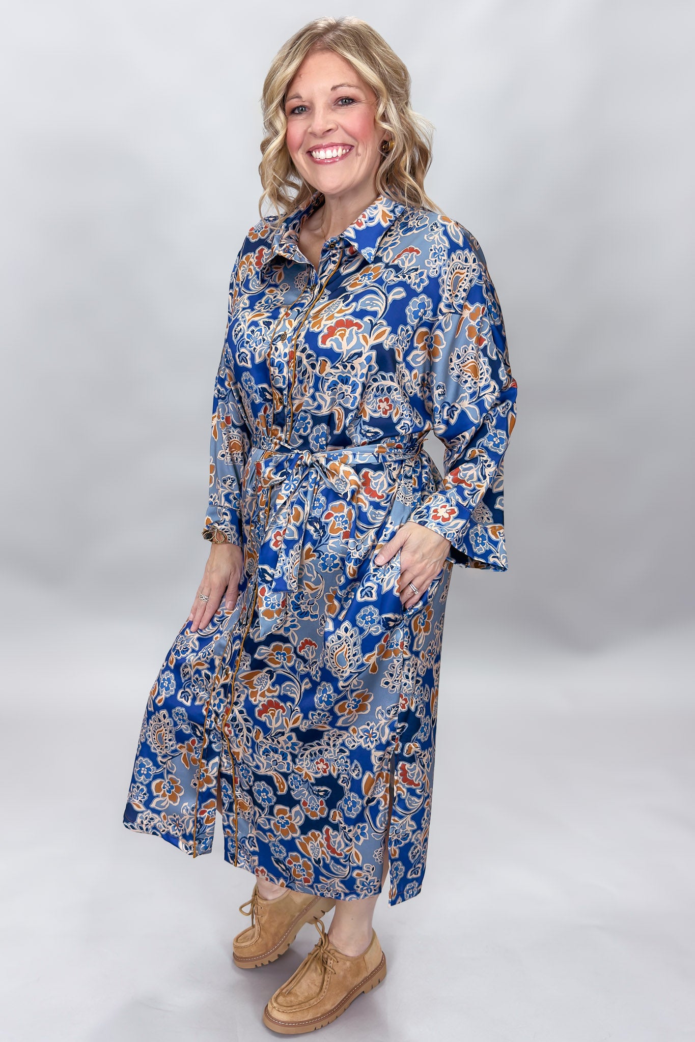 Uncle Frank blue floral satin midi dress with collar and waist tie; angled model view.