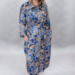 Uncle Frank blue floral satin midi dress with collar and waist tie; front model view.