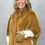 Ivy Jane camel faux fur cape with concealed snaps and patch pockets; angled model view.