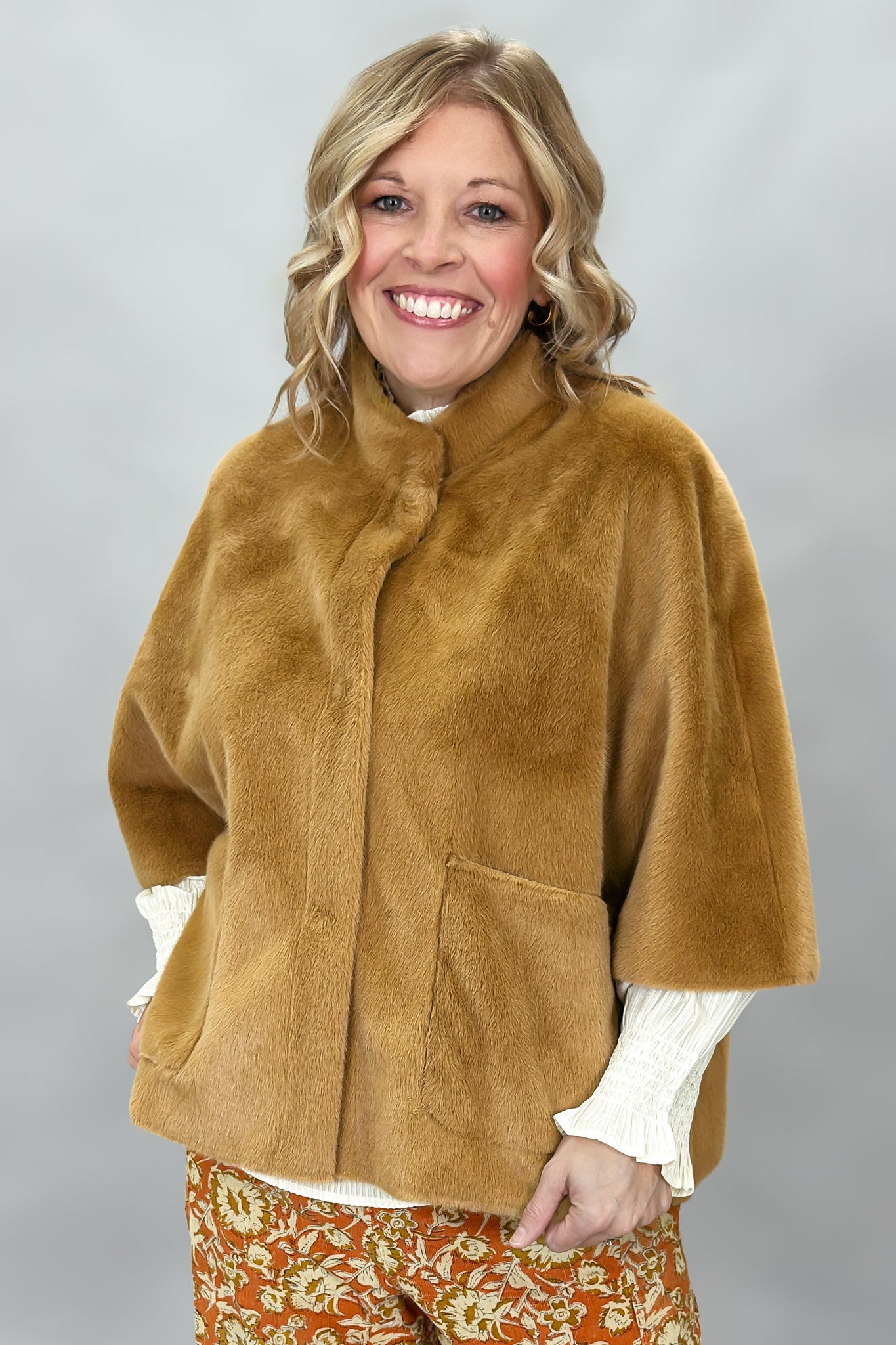 Ivy Jane camel faux fur cape with concealed snaps and patch pockets; front model view.