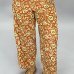 Ivy Jane orange, cream and green floral wide-leg pants; front model view.