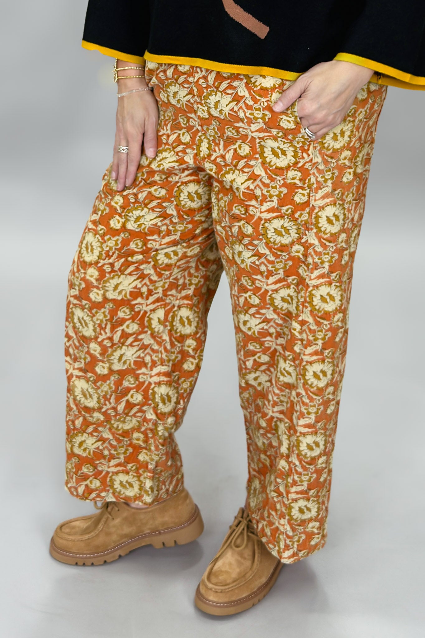 Ivy Jane orange, cream and green floral wide-leg pants; angled model view.