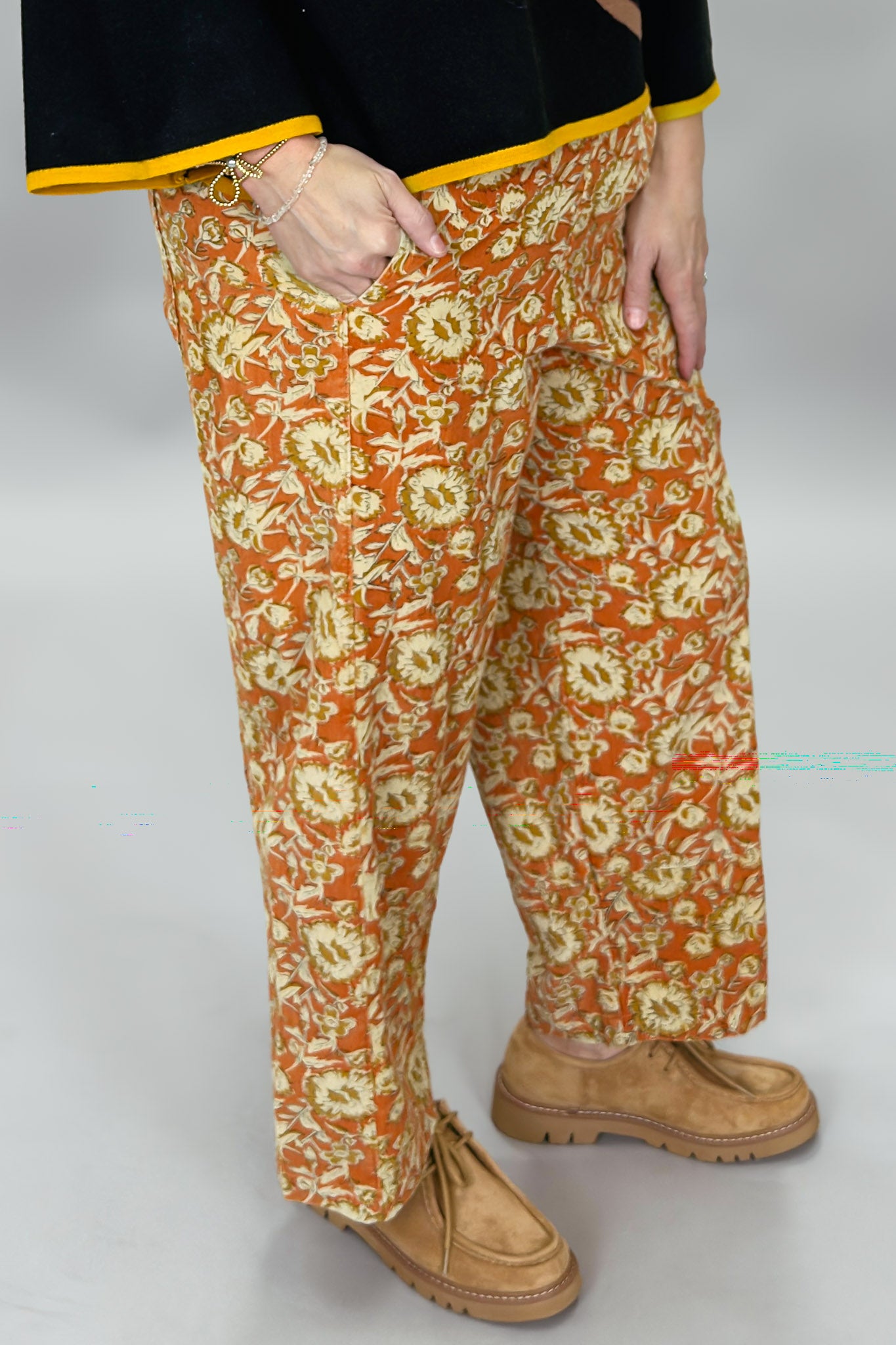Ivy Jane orange, cream and green floral wide-leg pants; angled model view.