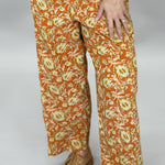 Ivy Jane orange, cream and green floral wide-leg pants; front model view.