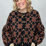 Ivy Jane black quilted jacket with brown stars and squares; front model view.