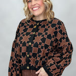 Ivy Jane black quilted jacket with brown stars and squares; angled model view.