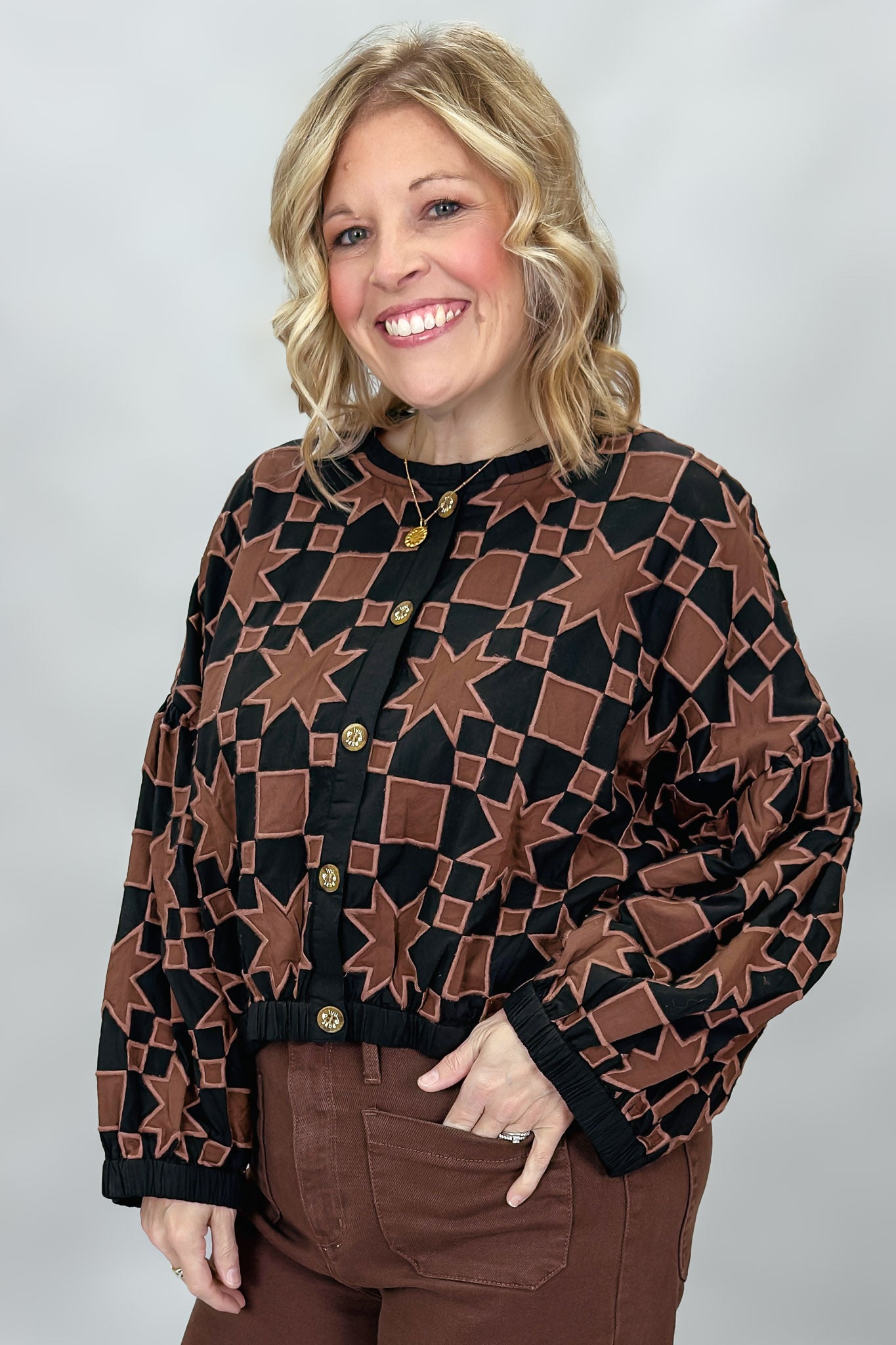 Ivy Jane black quilted jacket with brown stars and squares; angled model view.