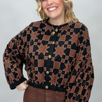 Ivy Jane black quilted jacket with brown stars and squares; front model view.