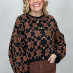 Ivy Jane black quilted jacket with brown stars and squares; front model view.