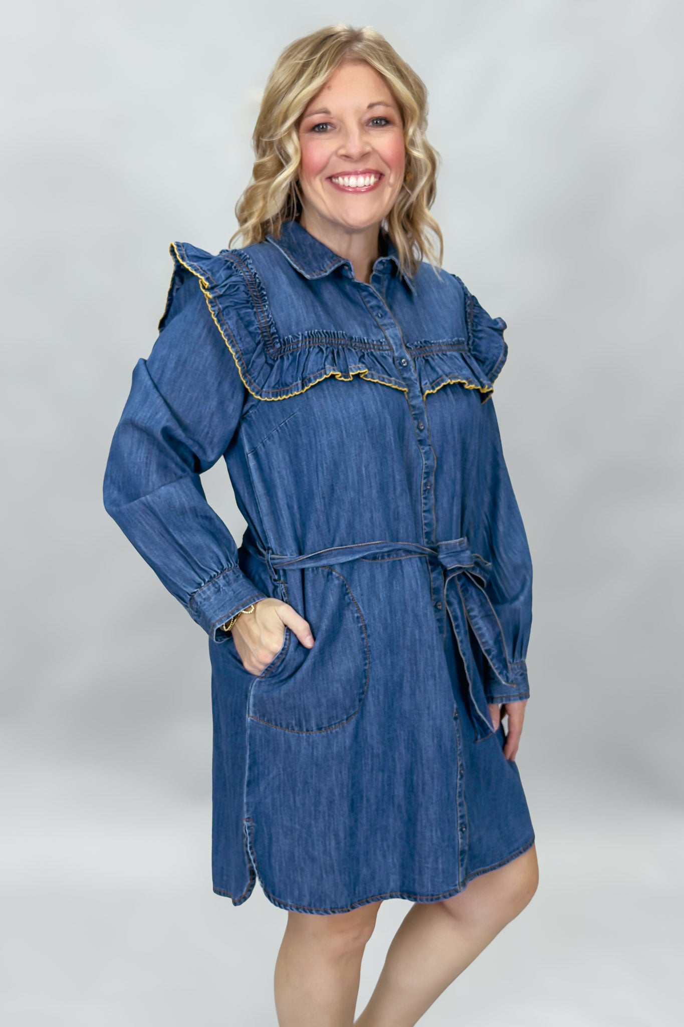 Ivy Jane blue denim mini dress with ruffled yoke and waist tie; front model view.