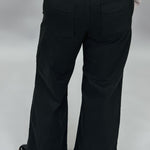 Just Black Denim black wide-leg jeans with front seam detail; back view.
