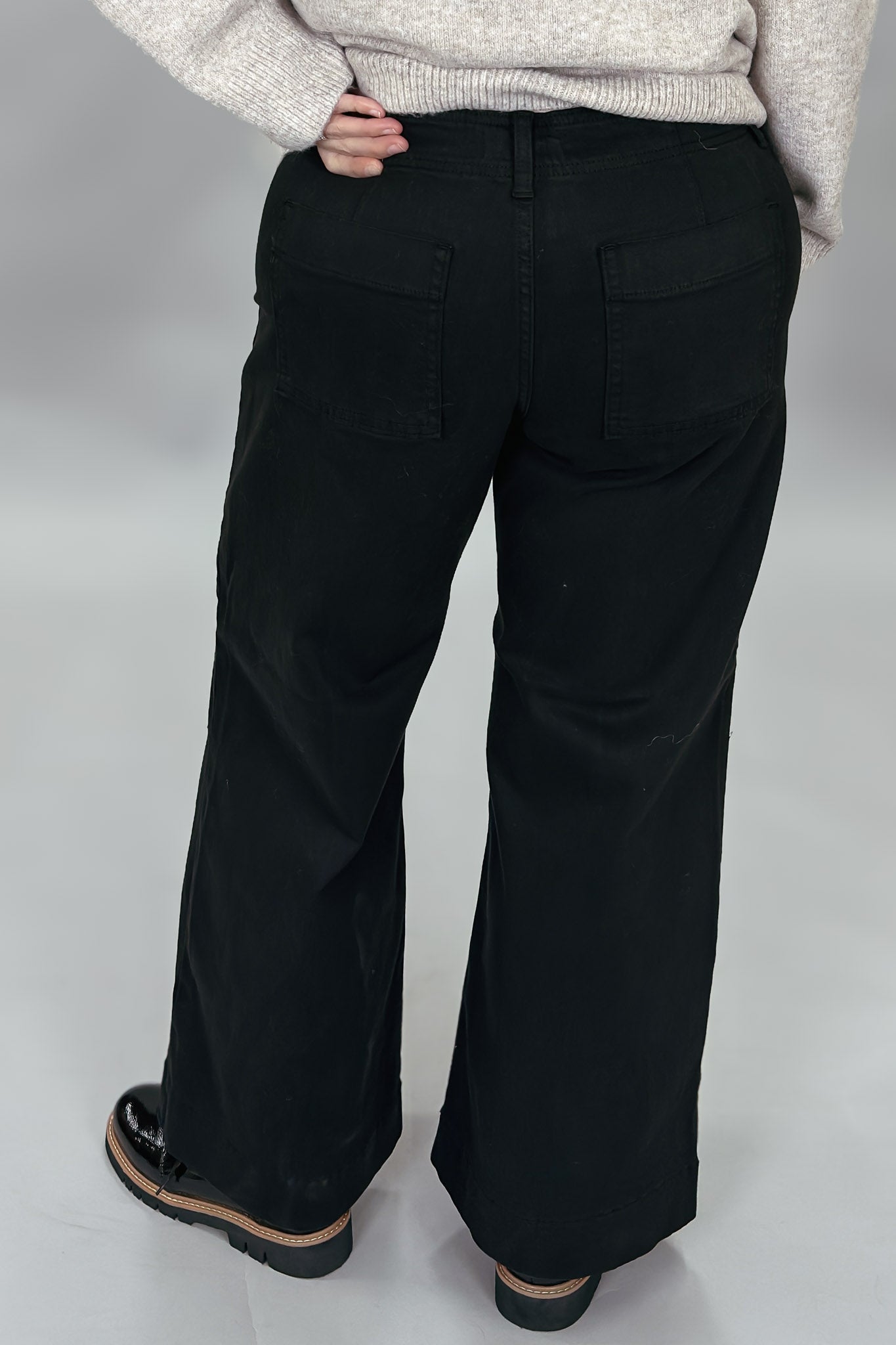 Just Black Denim black wide-leg jeans with front seam detail; back view.