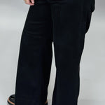 Just Black Denim black wide-leg jeans with front seam detail; angled model view.