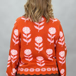 THML orange and pink floral mock-neck sweater with scalloped edges; back view.