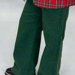 Just USA forest green straight-leg jeans with front and back pockets; angled model view.