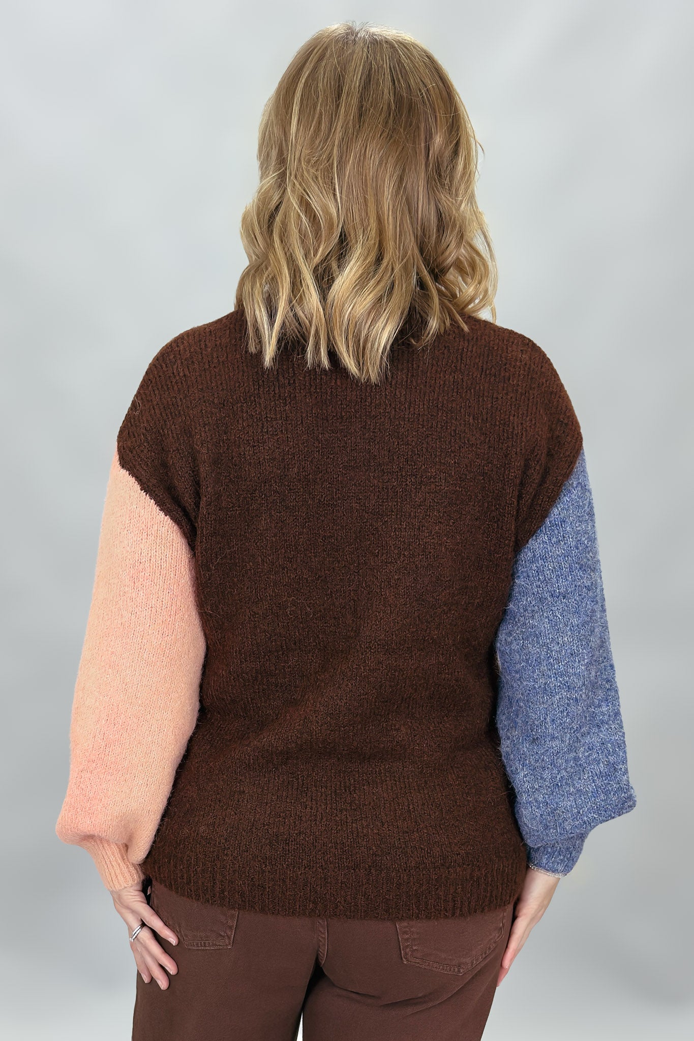 Compania Fantastica mocha sweater with blue and pink sleeves; back view.