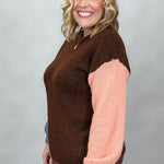 Compania Fantastica mocha sweater with blue and pink sleeves; angled model view.