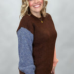 Compania Fantastica mocha sweater with blue and pink sleeves; angled model view.