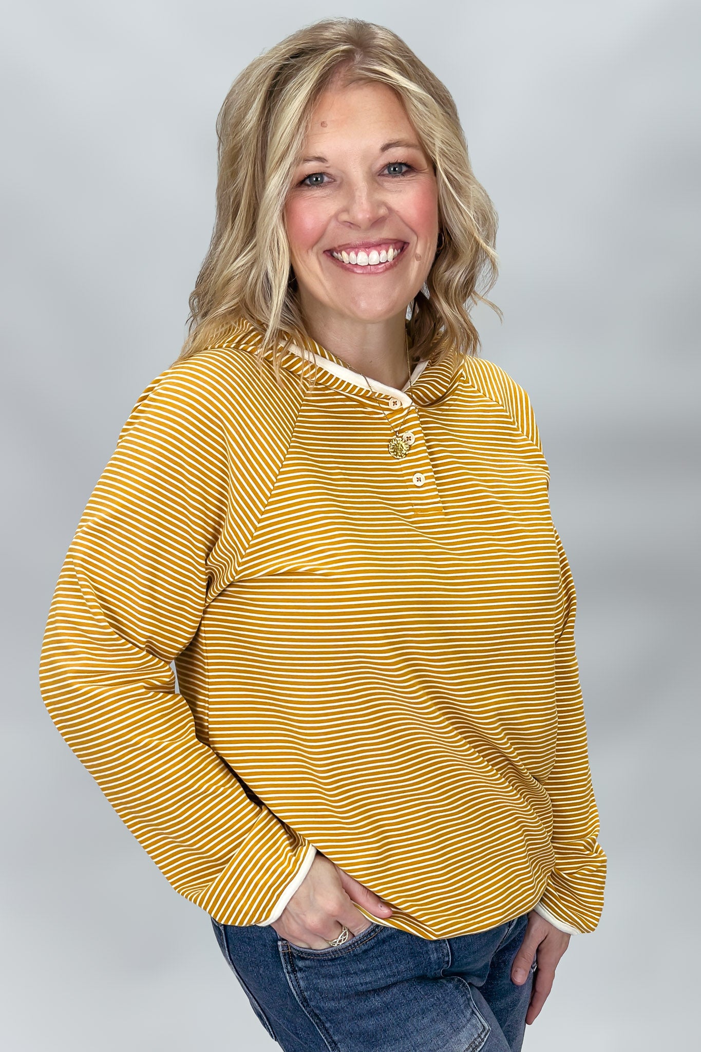 Mustard button-front hoodie showing contrast stripe detail