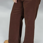 Just Black Denim brown straight-leg jeans with front patch pockets; angled model view.