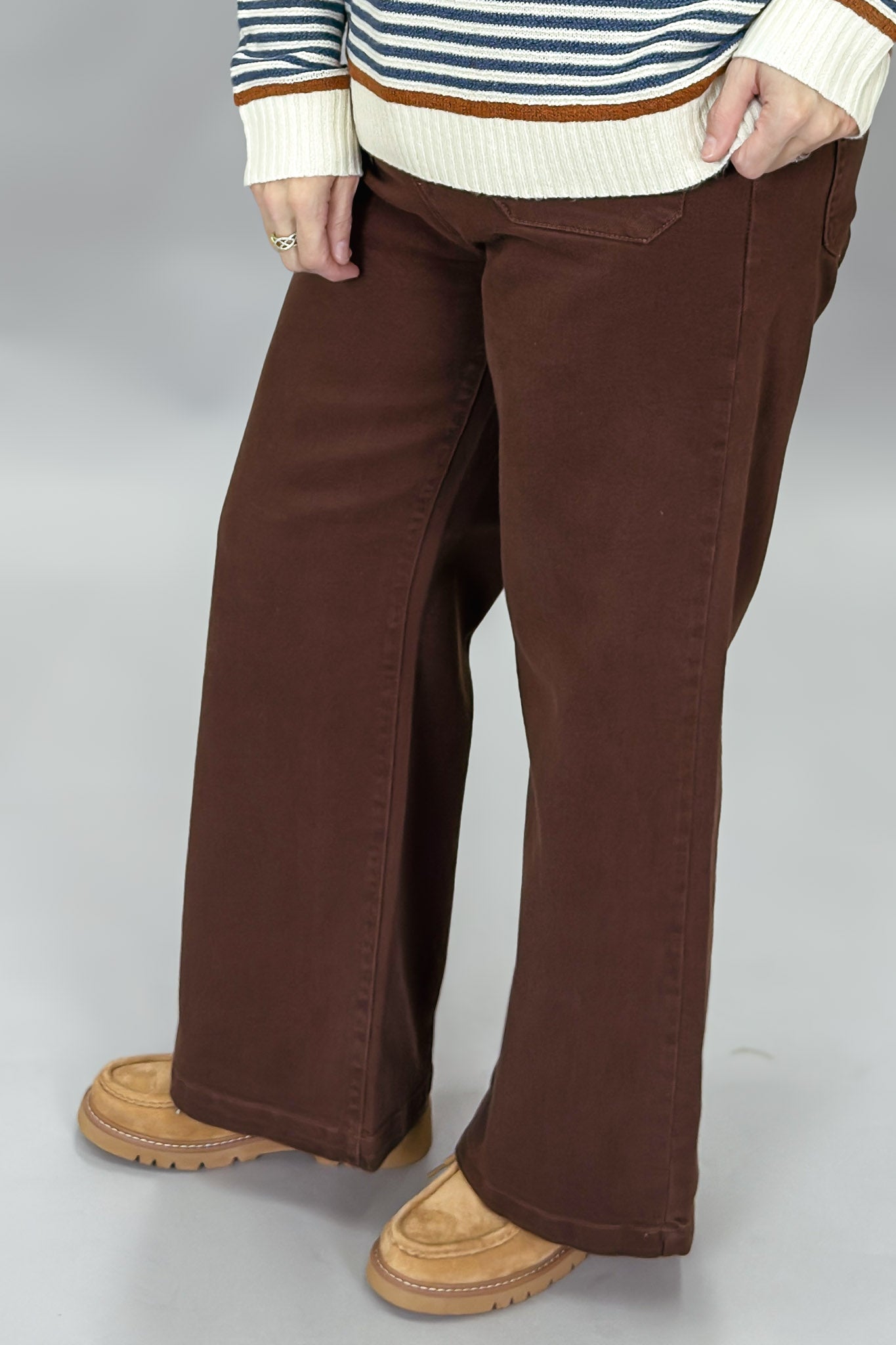 Just Black Denim brown straight-leg jeans with front patch pockets; angled model view.