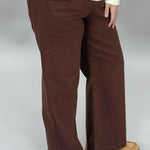 Just Black Denim brown straight-leg jeans with front patch pockets; angled model view.