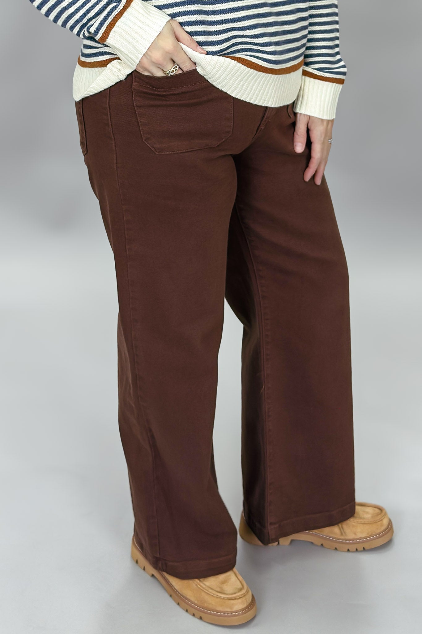 Just Black Denim brown straight-leg jeans with front patch pockets; angled model view.