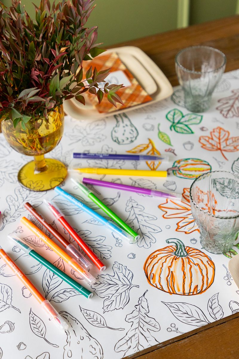 Autumn coloring runner partially colored in with markers and table decorations as display props