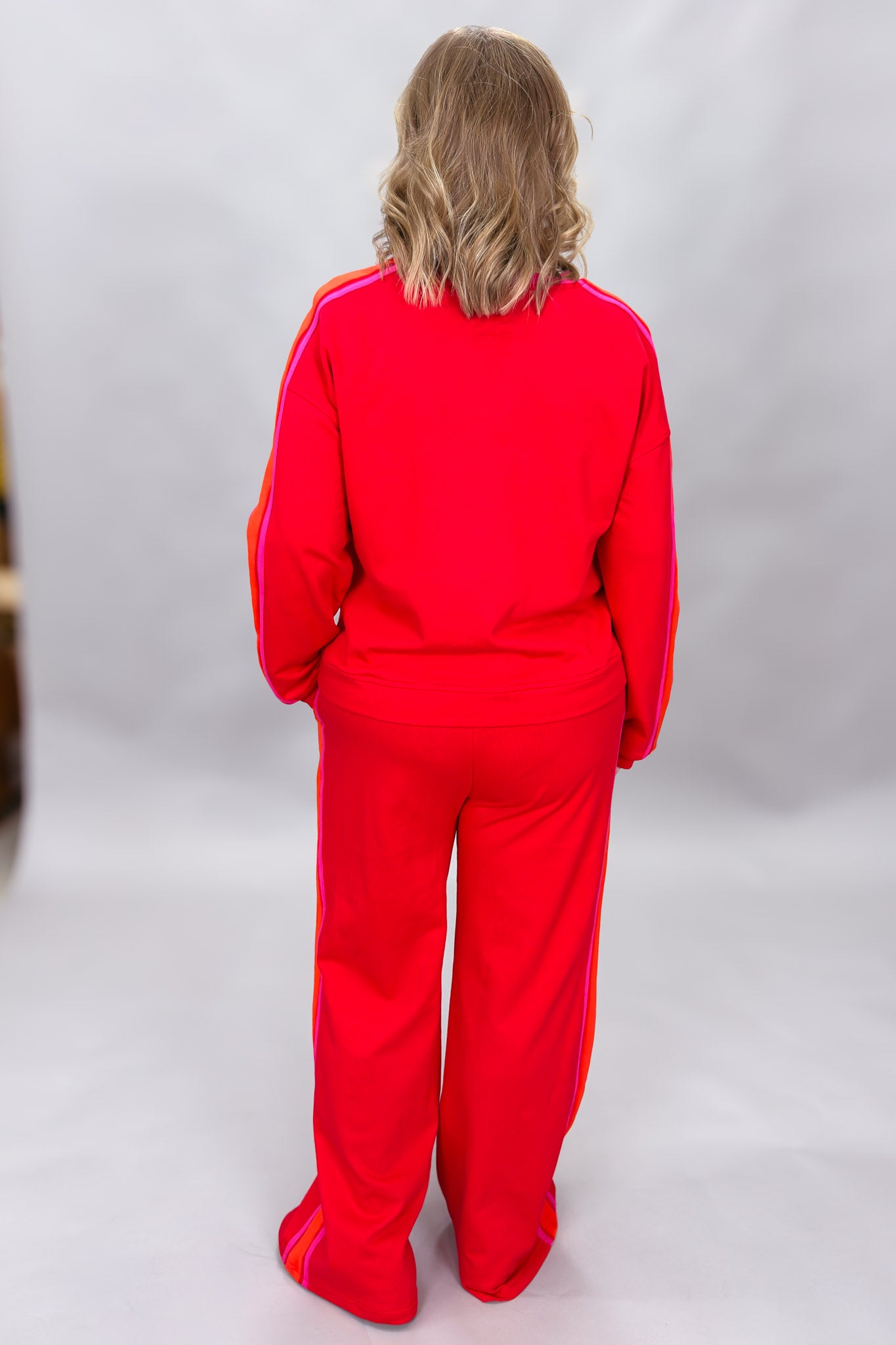 FATE red crewneck top and wide-leg pants set with pink stripes; back view.